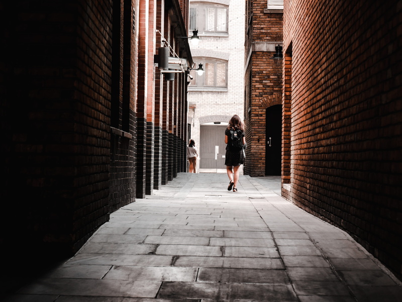real people, footpath, alley, built structure, woman, human, lifestyles, sidewalk, full length, city, building exterior, road, path, dress, footwear, outdoors