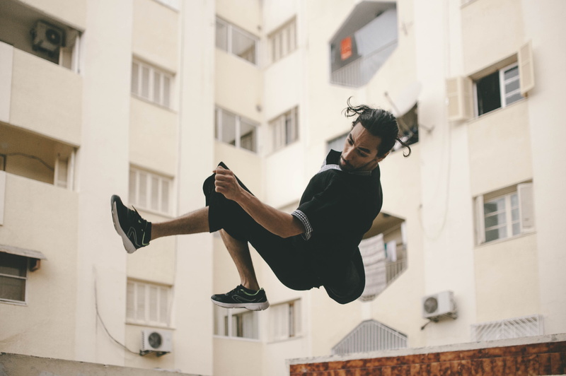 architecture, building exterior, vitality, real people, side view, parkour, hardwood, furniture, outdoors, apparel, running shoe, low angle view, full length
