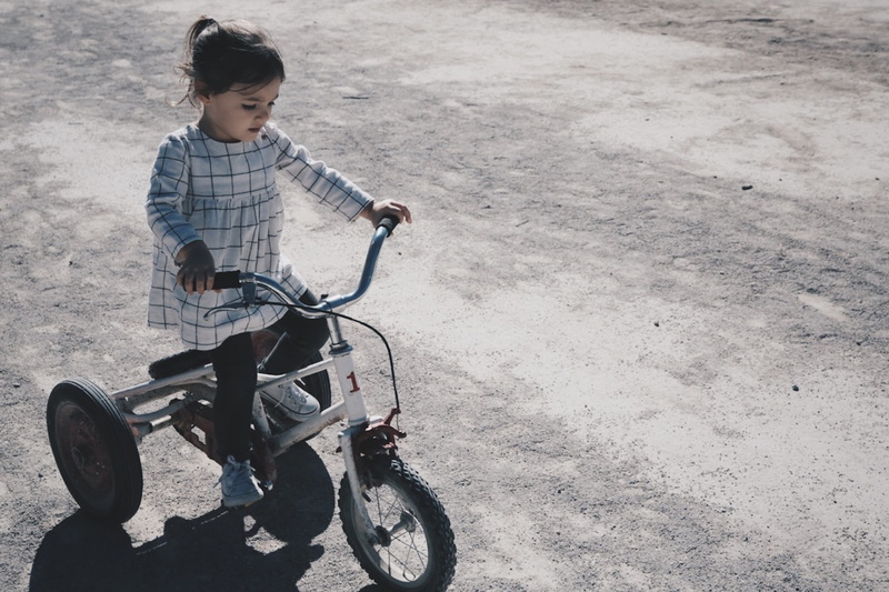 human Age, mode of Transport, girl, ethnicity, smiling, tricycle, time Of Day, one Person, adult, child, transportation, day, color Image, land vehicle