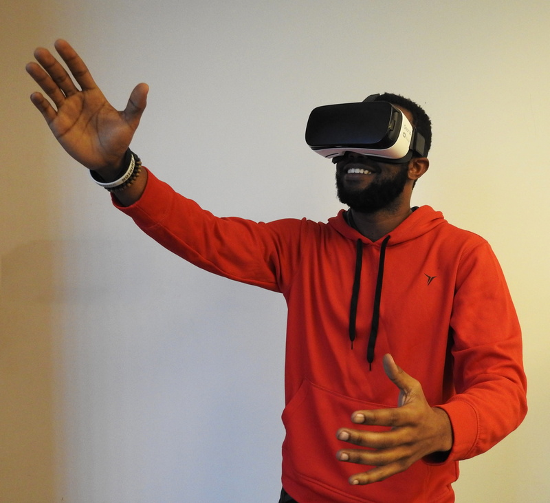 man, studio shot, african, white background, indoors, VR, orange, office, white, african american man, casual clothing, waist up, virtual reality, adult