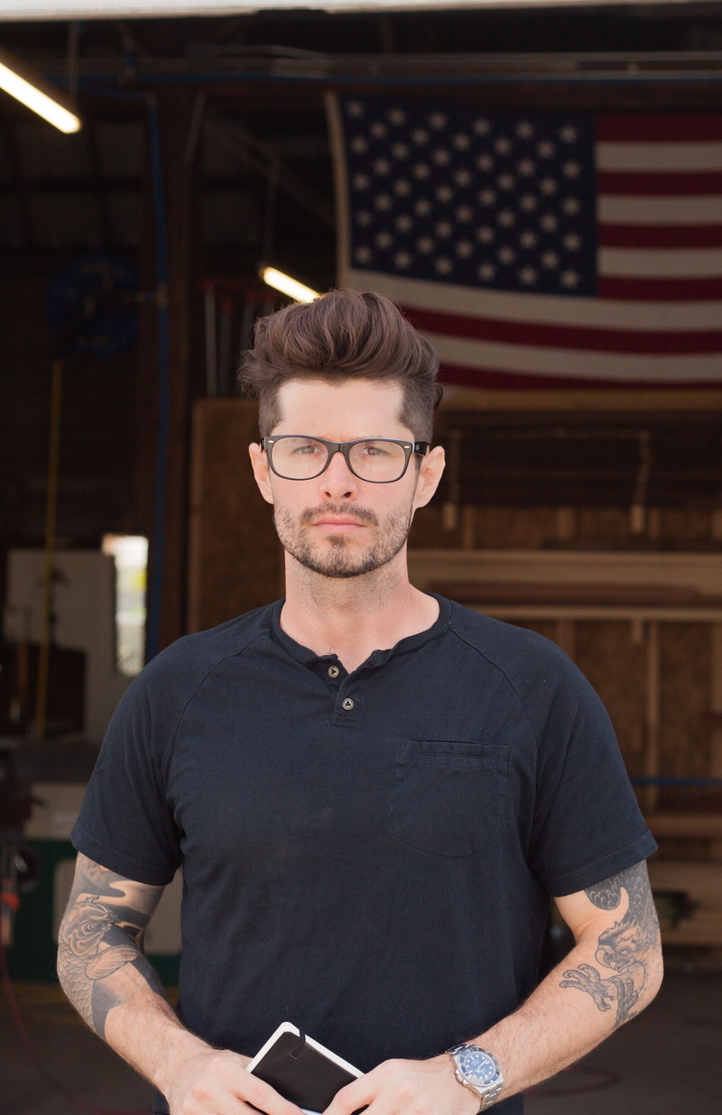 neckline, indoors, sleeve, person, casual clothing, shirt, looking at camera, leisure activity, t, clothing, standing, workshop, black, eyeglasses, young men