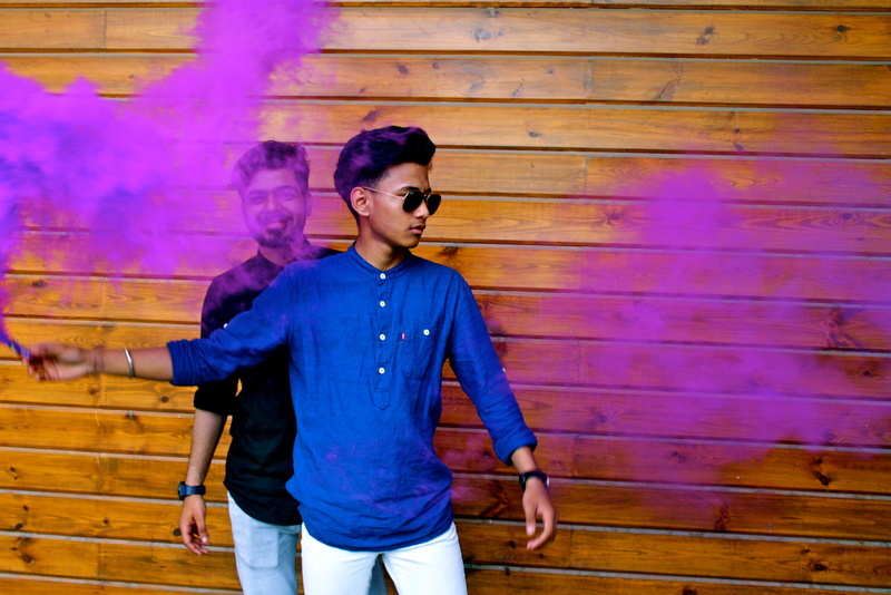 casual clothing, leisure activity, outdoors, wood - material, wearing, architecture, lifestyles, henley, sleeved, young, wear, activity, purple, pants