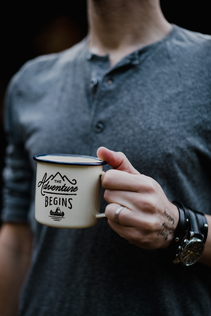 human body part, drink, one person, communication, indoors, wearing, man, text, western script, men, holding, mug, casual clothing, adult, sleeved, human hand
