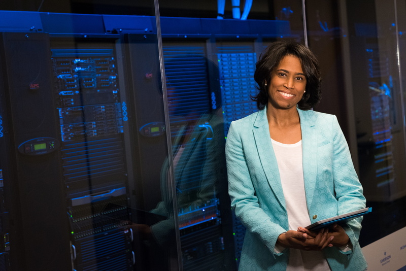 office, one person, commerce, smiling, remote work, standing, indoors, industry, business person, women, computer network, 5K, woman, adult, coat, room