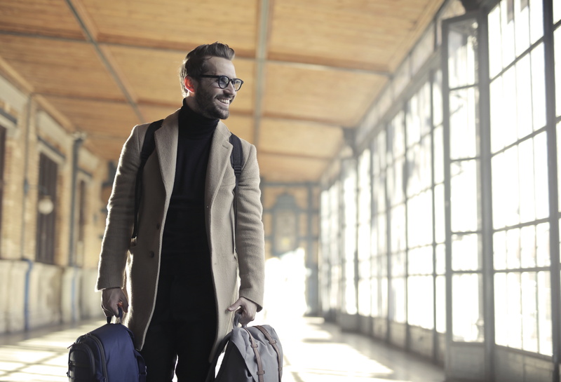 tourist, focus on foreground, front view, travel, man, architecture, lifestyle, suit, outerwear, briefcase, sunlight, happiness, daylight, smiling, street