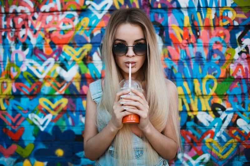 portrait, beautiful woman, overalls, one person, hairstyle, enjoyment, food and drink, blonde, graffiti, 1080P, young adult, sunglasses, drinking, face