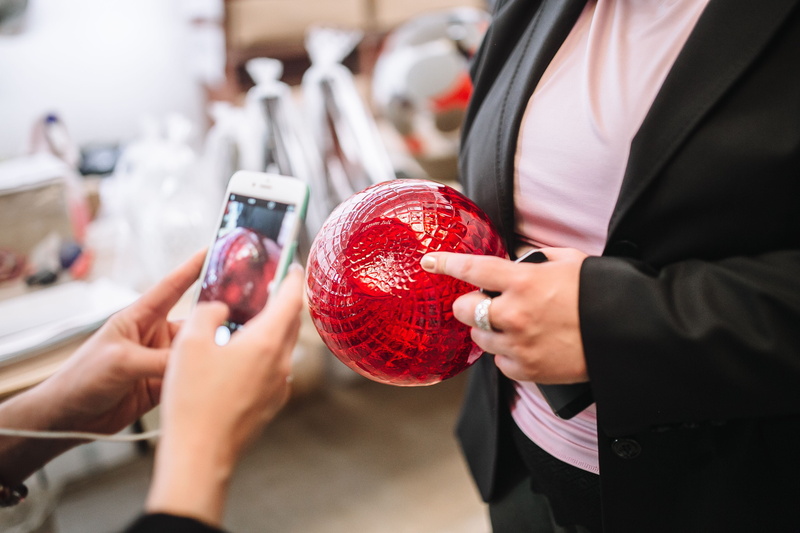 focus on foreground, handmade, men, caucasian Ethnicity, holding, glassworks, islands, human Hand, day, adult, red, indoors, human body part, midsection