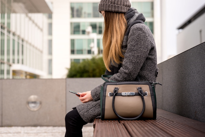 profile view, clothing, waiting, women, casual clothing, hat, woman, sitting, one person, hairstyle, outside, young women, bench, three quarter length