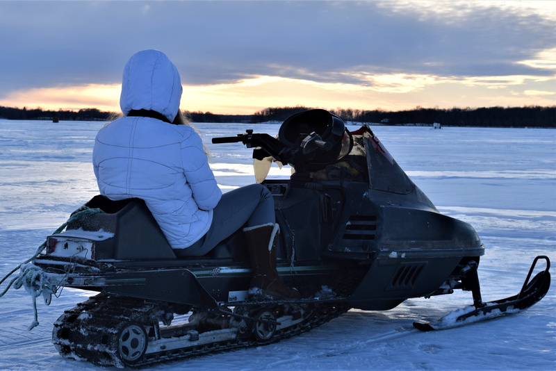 real people, fish house, snowmobile, junky, cold temperature, one person, lake, helmet, rear view, winter, cold, old, cloud - sky, sitting, leisure activity