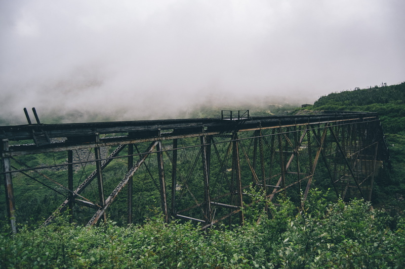 rural, non-urban scene, forest, white, bridge, land, outdoors, grey, mountain, field, roller coaster, safety, amusement park, built structure, fog, smoke - physical structure