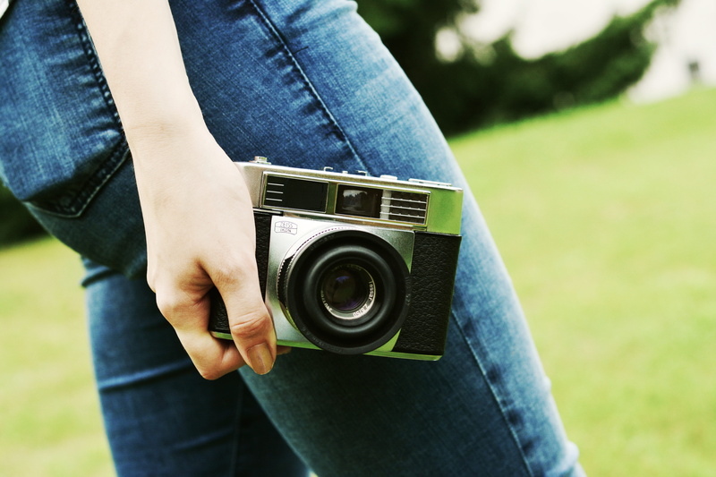camera - photographic equipment, photography, vintage, casual clothing, standing, technology, one person, leisure activity, photographing, camera, day