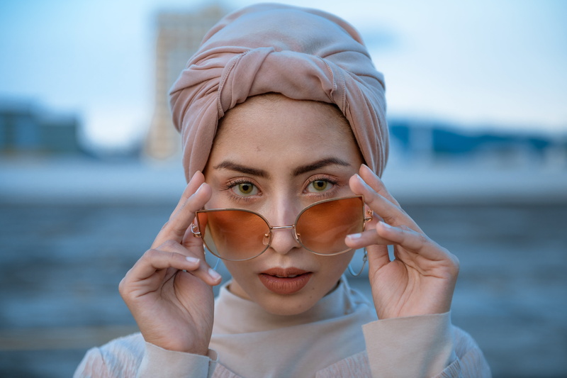 bonnet, day, looking at camera, women, touching, emotion, lifestyles, goggles, cleaning, female, beautiful woman, turban, headband, finger, young adult