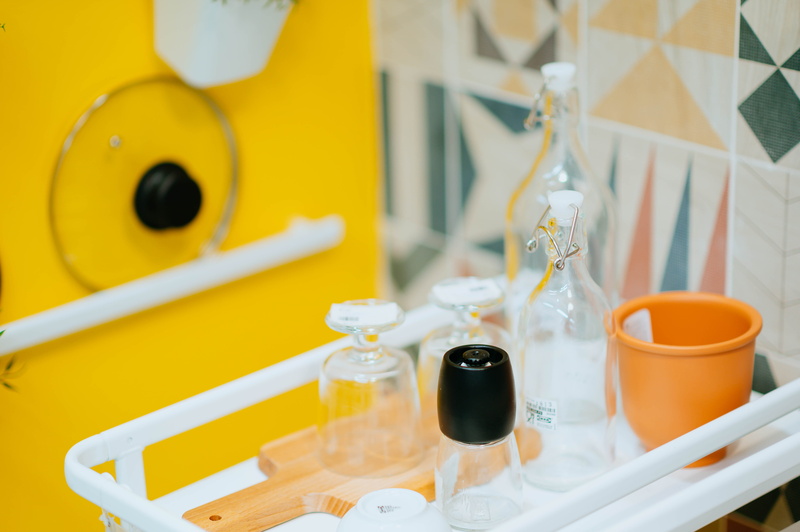 container, still life, cup, goggles, apparel, focus on foreground, clothing, coat, table, bowl, yellow, bottle, refreshment, selective focus, beer, drink