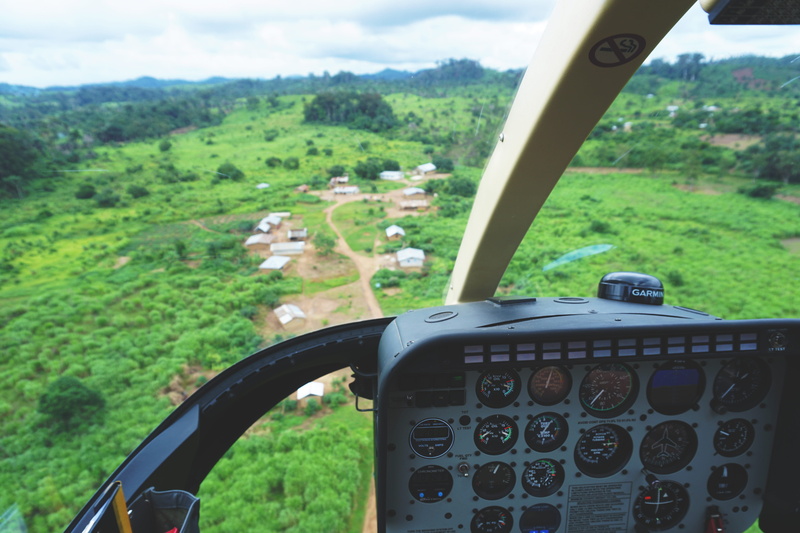 car, garmin, vehicle interior, air vehicle, dirt road, flying, no people, town, forest, land vehicle, glass - material, africa, environment, mode of transportation