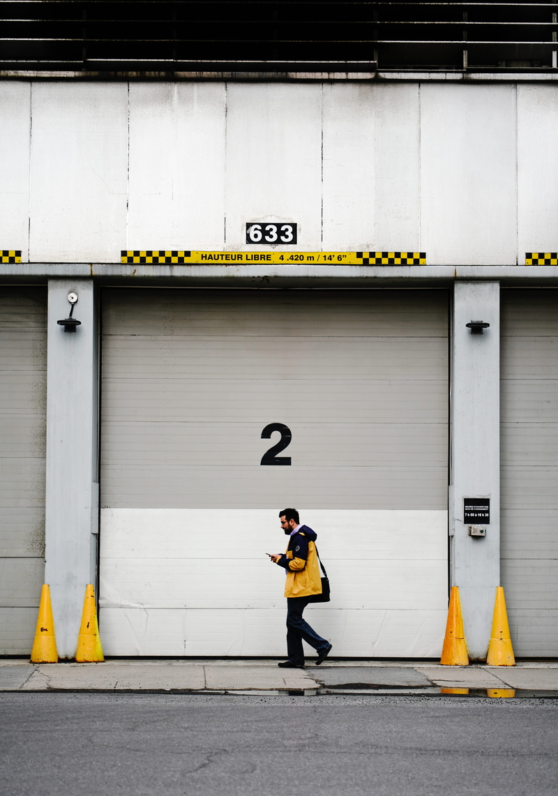 geometry, full length, hoodie, one person, airport terminal, transportation, real people, concrete, day, black, male, number, built structure, jacket, wall - building feature