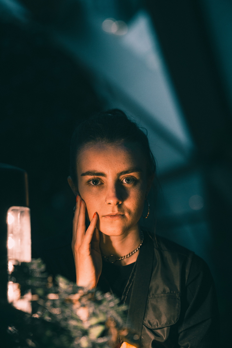 finger, person, drink, women, one person, casual clothing, bar counter, woman, face, young adult, jacket, beverage, lifestyles, headshot, night, human