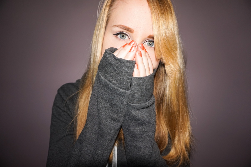 human body part, hiding, silence, studio shot, hand, brows, liner, green, front view, gray, hands, hands covering mouth, one person, blond, young, headshot