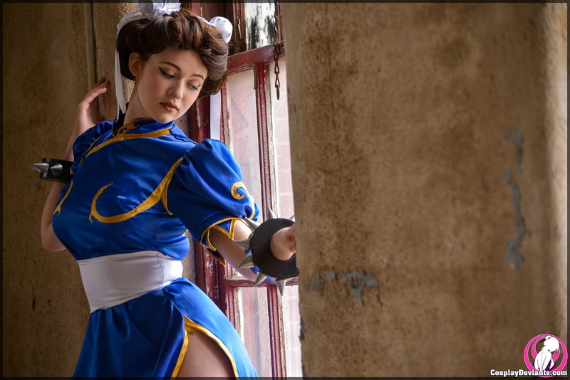 females, holding, built structure, clothing, Street Fighter, blue, waist up, young adult, one person, lifestyles, focus on foreground, leisure activity