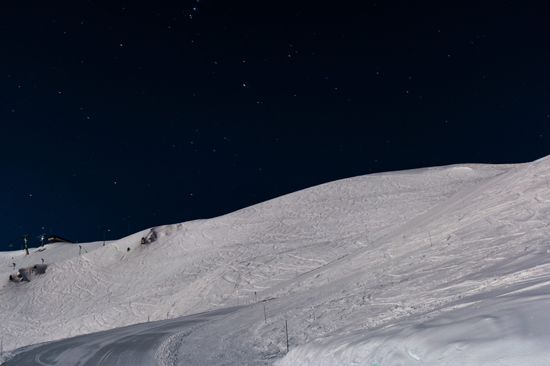 night atmosphere, beauty in nature, chair lift, landscape, space, tranquility, white color, slope, star, cold temperature, 5K, snowing, snowcapped mountain