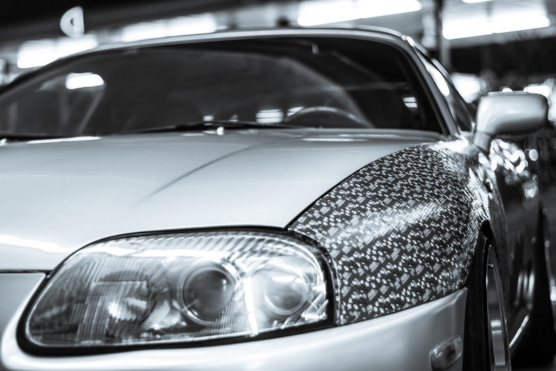 shiny, monochrome, retro styled, close-up, focus on foreground, no people, metal, chrome, mode of transportation, luxury, vehicle mirror, land vehicle
