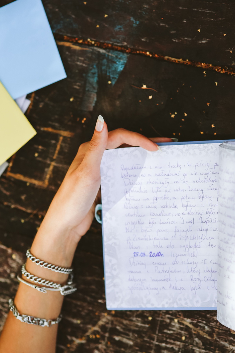 memoirs, women, Woman reading, holding, book, hands, diary, indoors, people, communication, woman, table, finger, publication, human body part, leisure activity