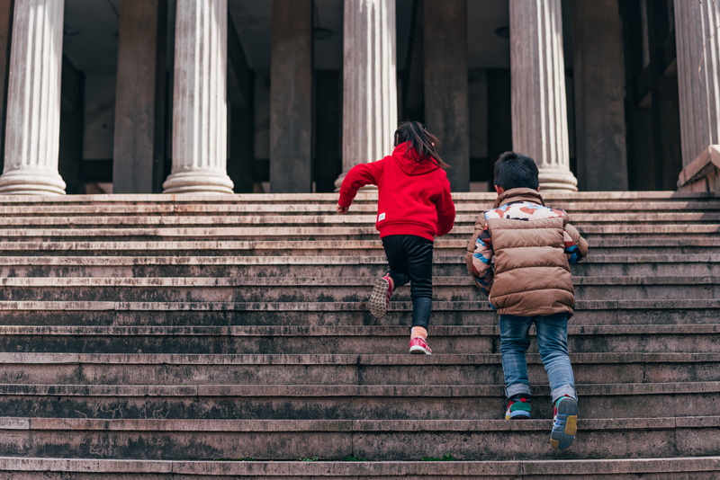 warm clothing, real people, males, building, banister, shrine, two people, boy, outdoors, bonding, denim, lifestyles, built structure, clothing, steps and staircases
