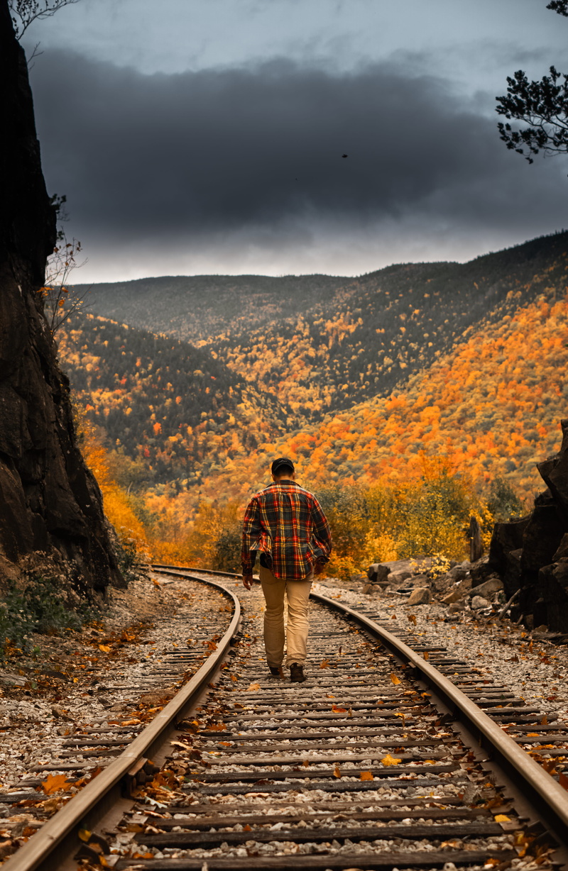 one person, real people, sky, change, beautiful, railroad, autumn, scenics - nature, rear view, person, transportation, mountains, landscape, full length