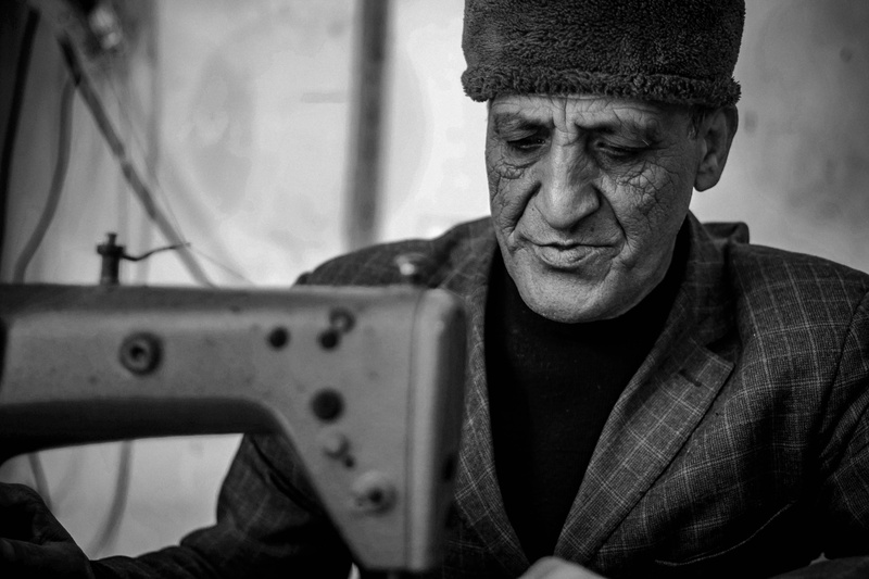 indoors, creative, working, homepage, mature adult, stains, front view, adult, men, hat, focus on foreground, sewing machine, blue, sewing, headshot, mature men