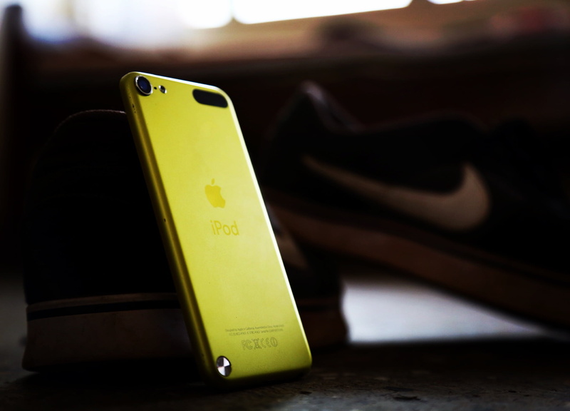 no people, music player, ipod touch, yellow, dark, communication, studio shot, ipod, indoors, connection, mobile phone, text, black color, digital tablet
