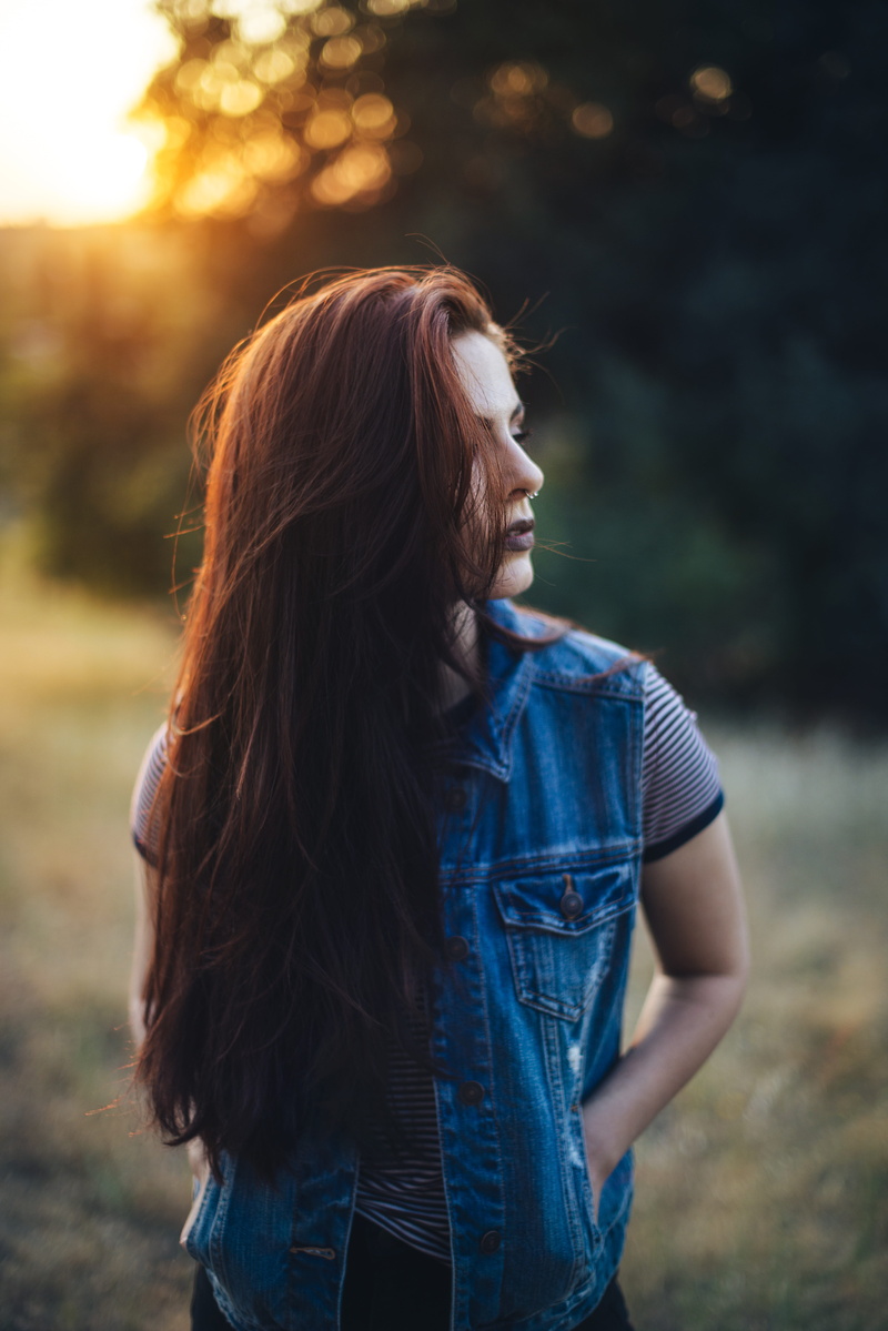 joy, hair, woman, emotional, face, standing, lifestyles, focus on foreground, fun, portrait, outdoors, happy, hairstyle, joyful, female, young, vest, fashion