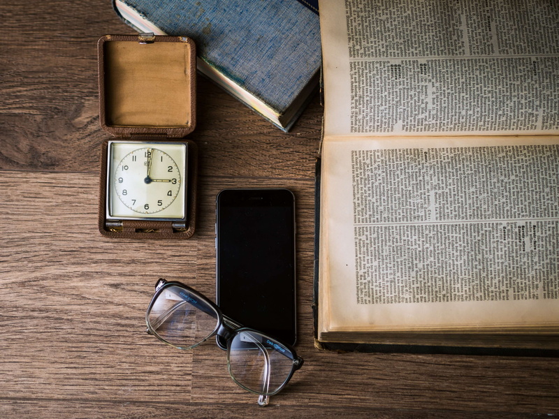 time, pages, no people, smartphone, communication, table, eyeglasses, book, connection, smart phone, still life, wood - material, portable information device
