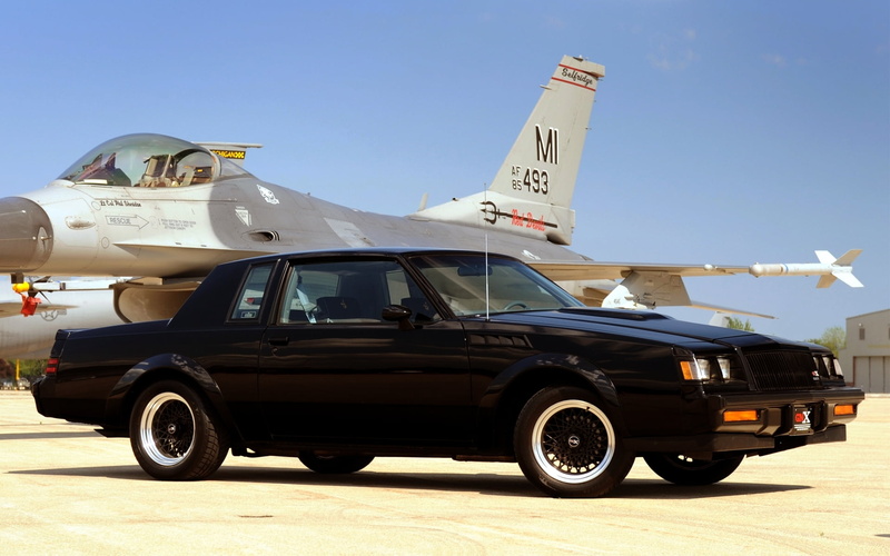 Buick, outdoors, clear sky, Grand National, stationary, motor vehicle, sunny, built structure, GNX, day, building exterior, fighter, no people, blue, mode of transportation