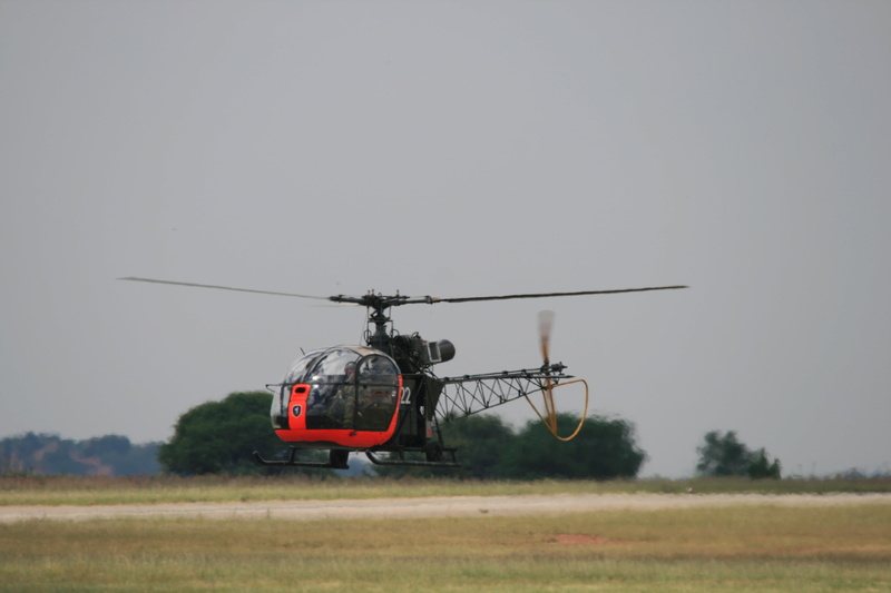 field, on the move, rotor, land, clear sky, south african air force museum, outdoors, sky, environment, armed forces, airborne, helicopter, airfield, flying