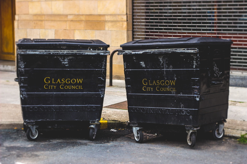 still life, garbage bin, city, day, communication, script, wheel, wall - building feature, abandoned, metal, number, street, old, close-up, outdoors, united kingdom