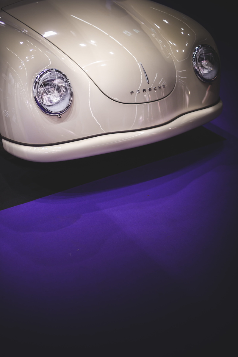 helmet, mode of transportation, retro styled, wealth, clothing, porsche, front, white, wheel, lamp, automobile, land vehicle, apparel, electric lamp, high angle view