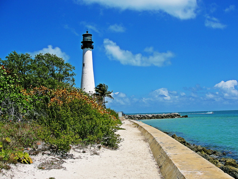 concrete, outdoors, water, lighthouse, plant, direction, tower, sky, beach, cloud - sky, tree, sea, built structure, building exterior, guidance, miami