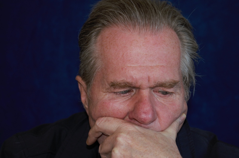mature adult, portrait, blue background, black, head, left, mouth, eyes, receding hairline, thinking, think, mature men, black background, body part, sadness
