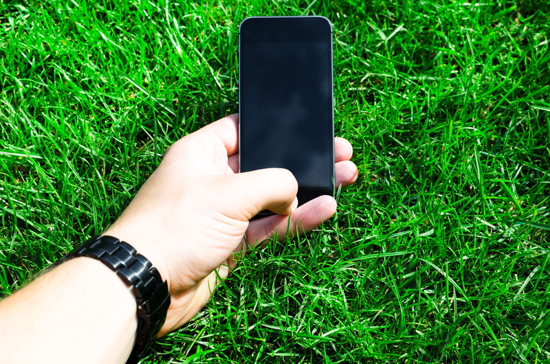 smart phone, green, looking, Grass, personal perspective, real people, message, human body part, white, wireless, black, typing, device, human hand, space