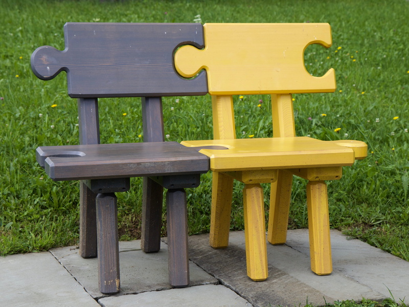 table, concrete, connected, puzzle, day, green, no people, green grass, surrounded, outdoors, field, grass field, daytime, yellow, absence, green color