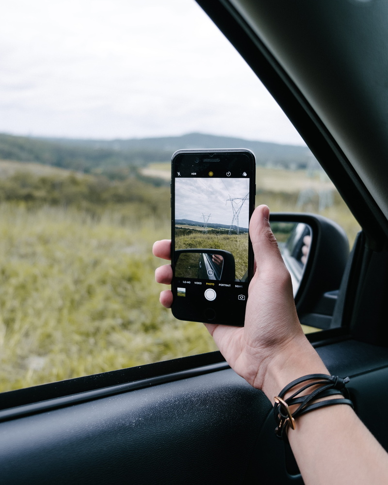 hand, gold coast, motor vehicle, iphone, real people, photography themes, technology, holding, phone, day, wireless technology, iphone 7 plus, vehicle interior