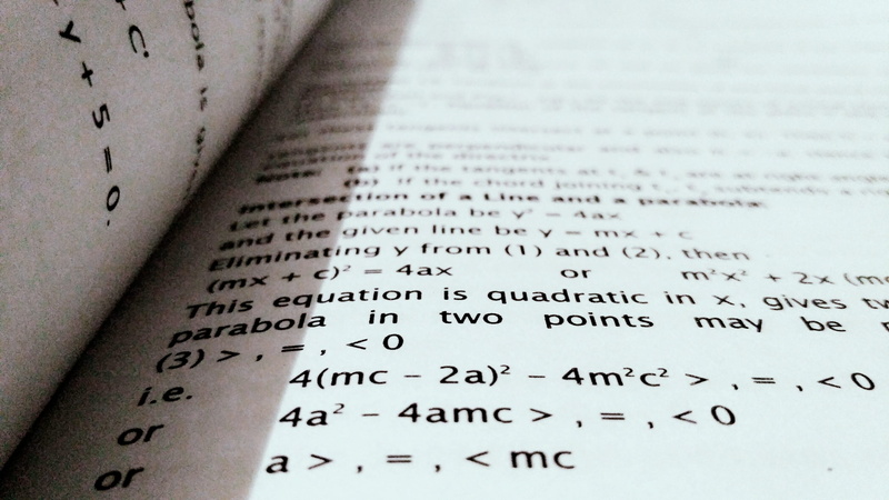 opened, book, western script, communication, high angle view, selective focus, indoors, publication, no people, school, equation, blur, mathematics, technology