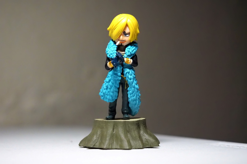 character, looking at camera, blue, holding, piece, television, warm clothing, figurine, fictional, human representation, women, anime, full length, indoors