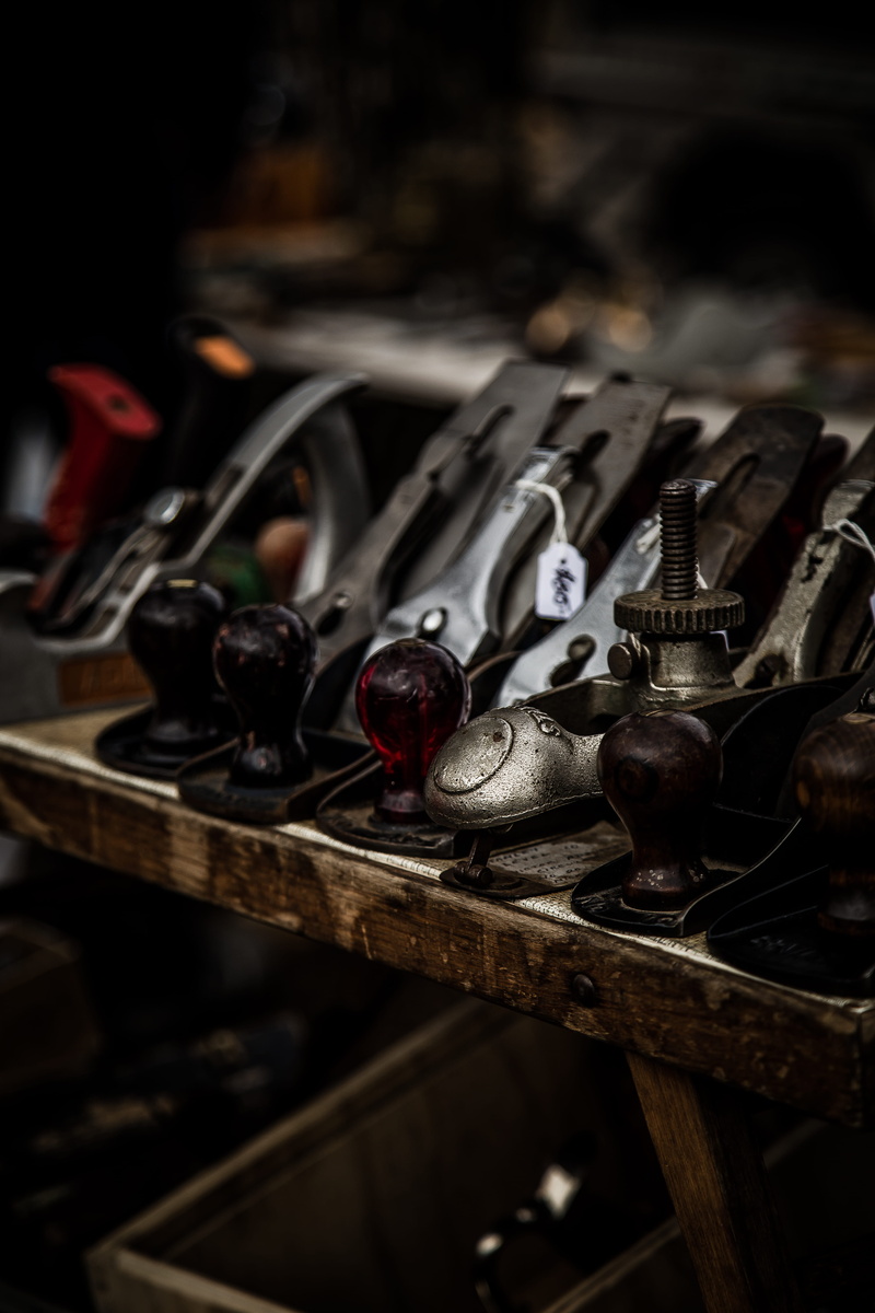 workshop, label, price tag, high angle view, variation, container, wood, metal, repairing, placed, still life, board, hand tool, pile, focus on foreground