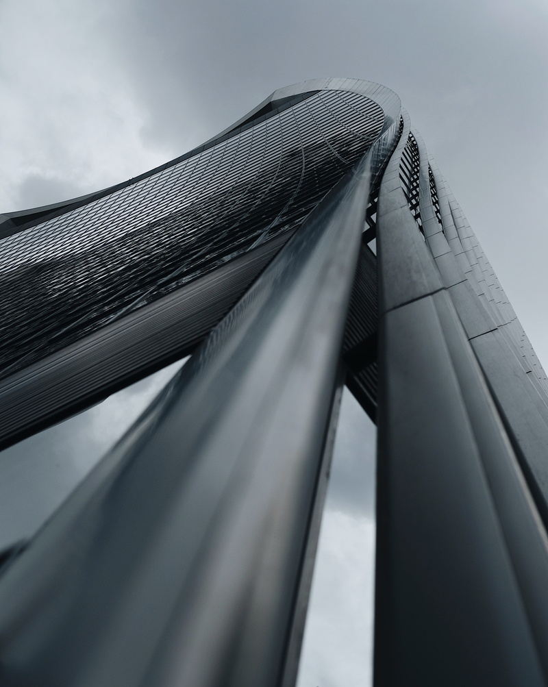 outdoors, directly below, suspension bridge, selective focus, city, looking up, cloud - sky, 16mm, bridge, low, day, building, angle, sky, tower, tall - high
