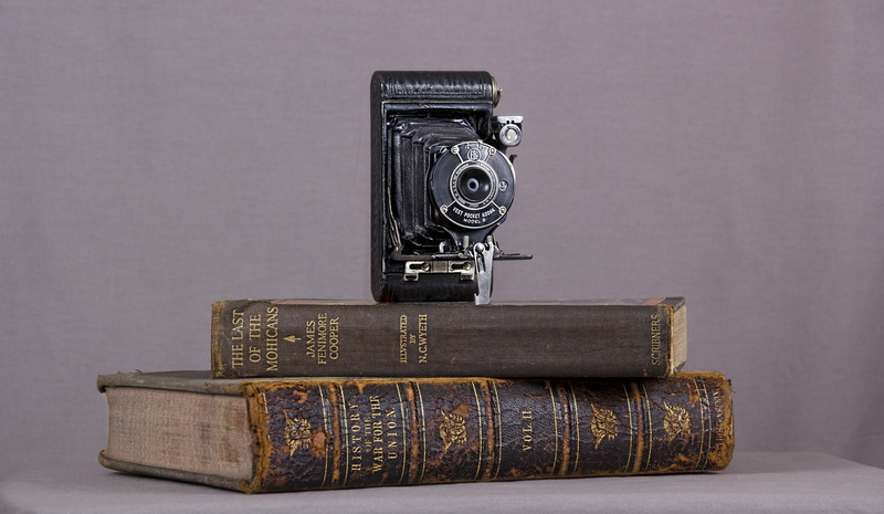 studio shot, old, text, simplicity, learning, close-up, gray background, folding, top, indoors, stack, 5K, gray, single object, no people, history, camera
