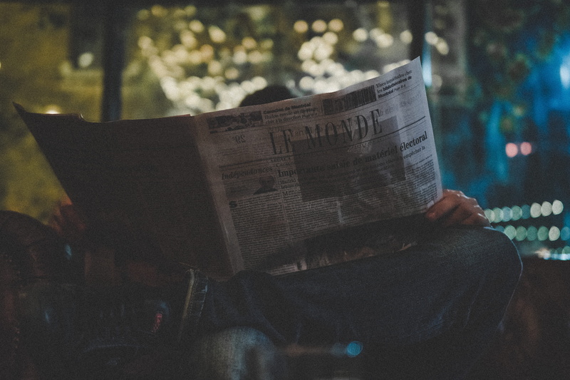 bokeh, men, one person, night, blade, reading, start, le monde, sitting, starwar, read, neon light, communication, jeans, western script, activity, the media