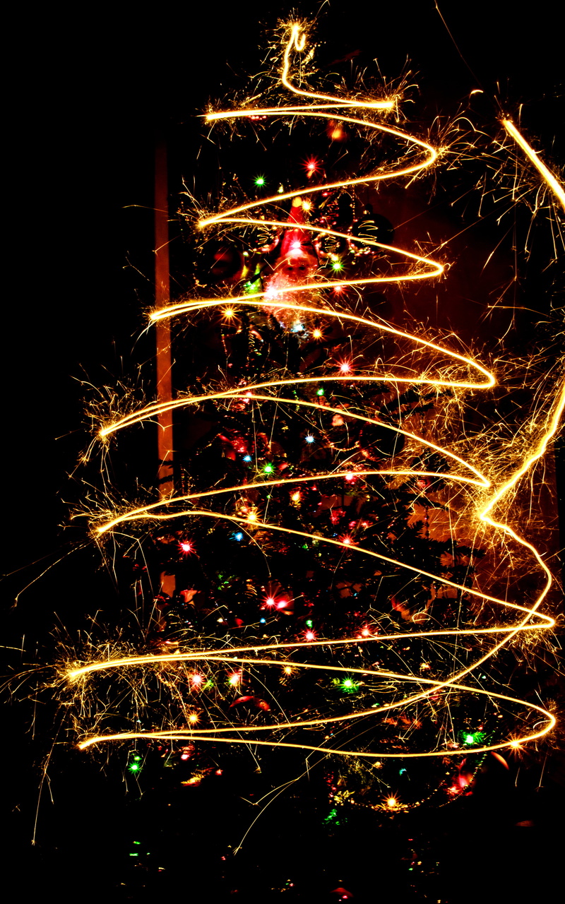 illuminated, holiday - event, bright, christmas, low angle view, sparks, yellow, fire - Natural Phenomenon, celebrate, sparkler, arts culture and entertainment