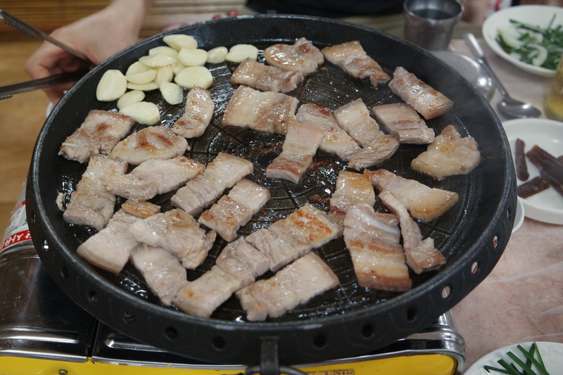 cooking pan, ready-to-eat, korean food, high angle view, restaurant, health food, pork, table, iron, household equipment, dining room, japanese food, kitchen utensil