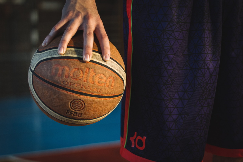 adult, close-up, western script, person, 5K, molten, focus on foreground, ball, communication, lifestyles, man, hand, text, basketball, human hand, finance