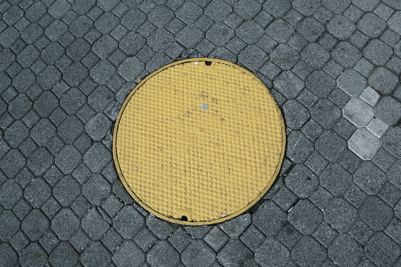 day, pattern, design, pavement, sign, roadside, waste, no people, drain, shape, sewage, lid, circle, cover, texture, directly above, symbol, iron, sanitation
